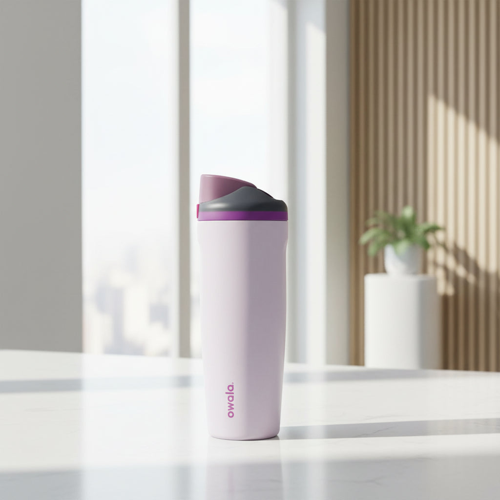 Purple water bottle with a purple and pink cap on a white background