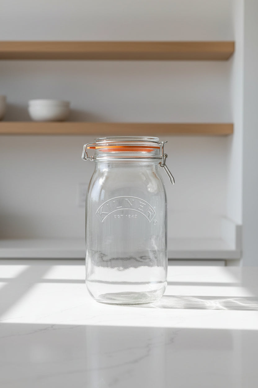 Clear glass jar with airtight lid on a white background, featuring the Kilner brand.