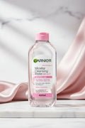 A 400ml bottle of Garnier Micellar Cleansing Water All-in-1 for sensitive skin, featuring a clear bottle with a pink flip-top cap and pink and green branding on the front label.