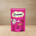 Pink package of Dreamies cat treats with cartoon cat and mouse, and text 'Dreamies with beef'.
