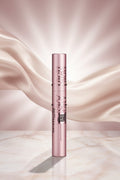 Maybelline eyelash serum with pink packaging on a white background