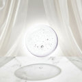 A close-up of a clear, transparent gel or liquid droplet with small embedded air bubbles on a white background.