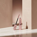 Maybelline Lash Sensational mascara with pink packaging and black wand on white background