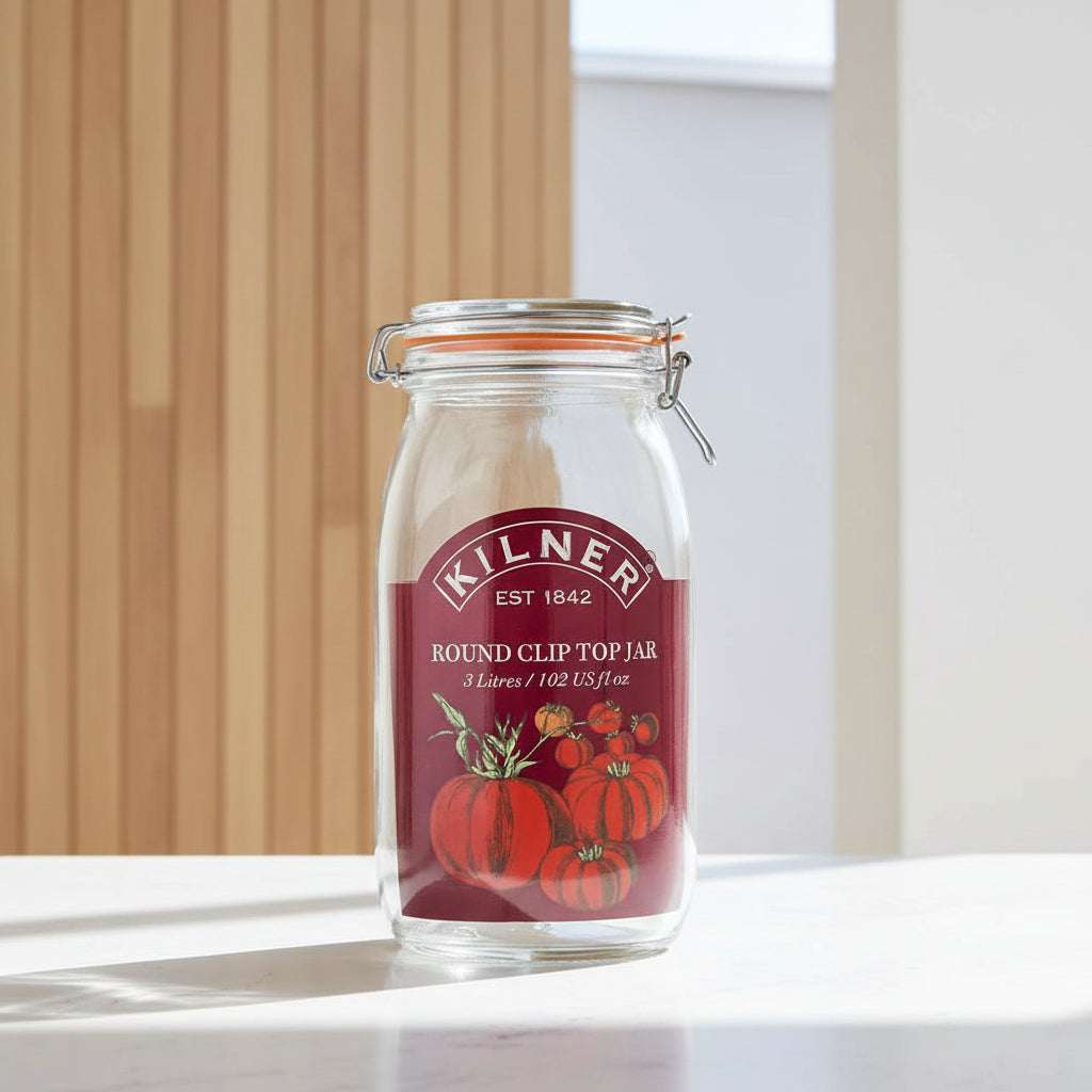 Kilner 3 Litre round clip-top jar with a clear glass body, orange rubber seal, metal wire bail, and a dark red label featuring tomatoes.