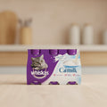 A 6-pack of Whiskas Cat Milk wet cat food in a purple and white cardboard multipack. The packaging features a photo of a grey tabby cat on the left, a splash of milk on the right, and three individual purple lids visible at the top.