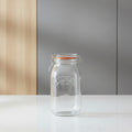 A clear Kilner glass jar with a metal clamp lid and orange-brown rubber gasket, shown on a white background with dimension lines indicating 25.4 cm height and 12.