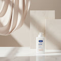 Person applying E45 moisturizing lotion to their skin with text about long-lasting care for dry and sensitive skin.