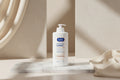Person applying E45 moisturizing lotion to their skin with text about long-lasting care for dry and sensitive skin.