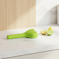 Green kitchen tool with multiple uses on a white background
