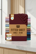 Stack of Utopia Bedding fitted sheets with a maroon sheet on top and color swatches below.