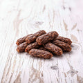 Dog treats on a wooden surface with a 'Dog' bowl in the background