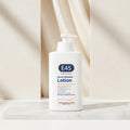 E45 moisturizing lotion bottle with usage instructions on a peach background