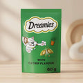 Dreamies catnip-flavored wet cat food pouch in green, featuring the Dreamies logo, a cartoon cat, a small potted plant, and the text 'WITH CATNIP FLAVOUR 60 g'.
