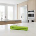 Green kitchen tool with dimensions labeled on a white background