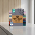 Stack of Utopia Bedding fitted sheets with color options and product details on a white background.