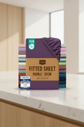 Stack of Utopia Bedding fitted sheets with a purple sheet on top, displayed against a white background.