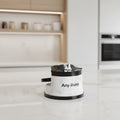 AnySharp knife sharpening stand with a white marble-patterned base, black accents, and a partially inserted steel knife, shown on a clean white background.