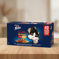 Purina Felix Doubly Delicious wet cat food pouch pack in a 40-count jumbo box. The packaging is dark blue with a cartoon black-and-white cat peeking out from torn paper, a bowl of wet food, and a red '40 POUCH JUMBO PACK' label.
