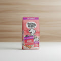 A 12kg bag of Barking Heads All Hounder Hair Necessities dog food, featuring a pink and red design with a cartoon dog and illustrations of salmon and carrots.