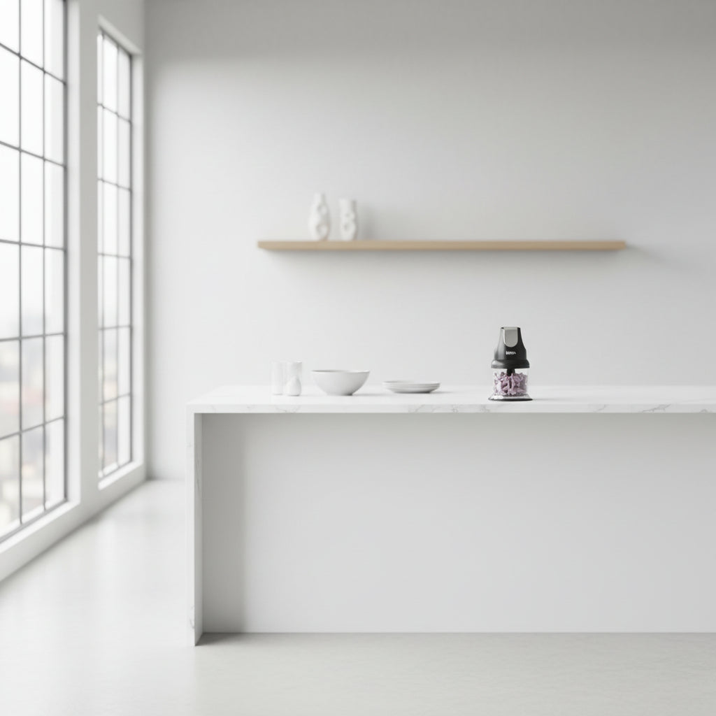 Person using a Ninja food chopper in a kitchen setting with vegetables on a cutting board.