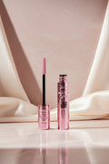 Maybelline Sky Lash Sensa Honal mascara shown with the wand applicator and the open tube, both in metallic pink packaging on a white background.