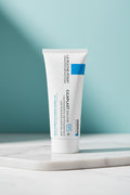 A white squeeze tube of La Roche+Posay Cicaplast Bump B5+ skincare balasm, featuring blue and black text and a blue square accent on the upper right side.