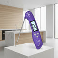 A purple digital meat thermometer with a long stainless steel probe, featuring an LCD screen showing 24.9 degrees Celsius, on a clean white background.