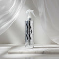 Silver spray bottle labeled 'WOW' on a white background