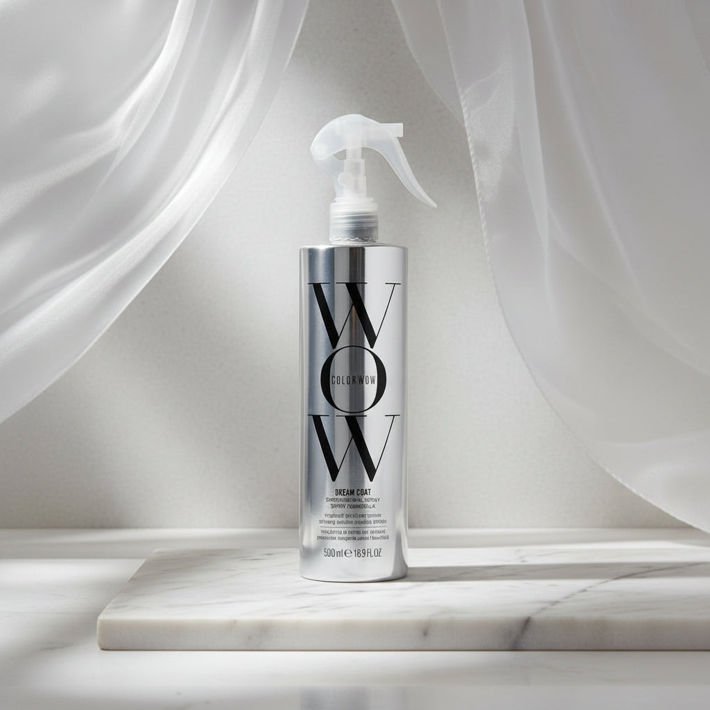 Silver spray bottle labeled 'WOW' on a white background