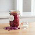 Jar of pickled red cabbage with a label on a wooden surface