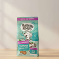A 2kg bag of Barking Heads All Hounder Tummy Loving Care dog food, featuring a teal and purple package design with a cartoon dog and fish illustration.