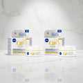 Two boxes and two jars of NIVEA Q10 Anti-Wrinkle Power Extra Firming Day Cream, displayed on a clean white background.