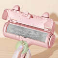 Pink pet hair remover with a clear roller showing collected hair against a light green background.