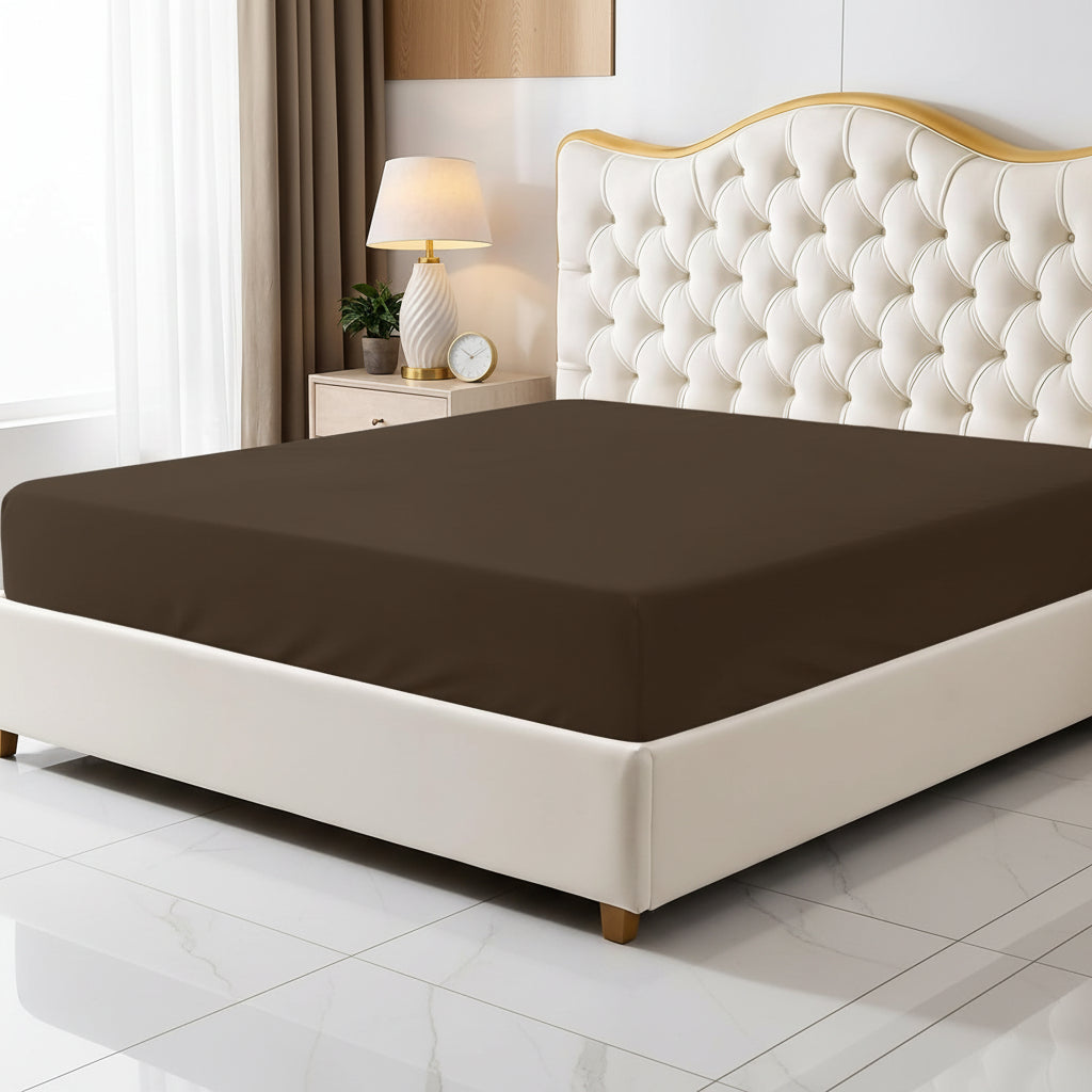 Brown fitted sheet on a bed with a decorative headboard and nightstand.