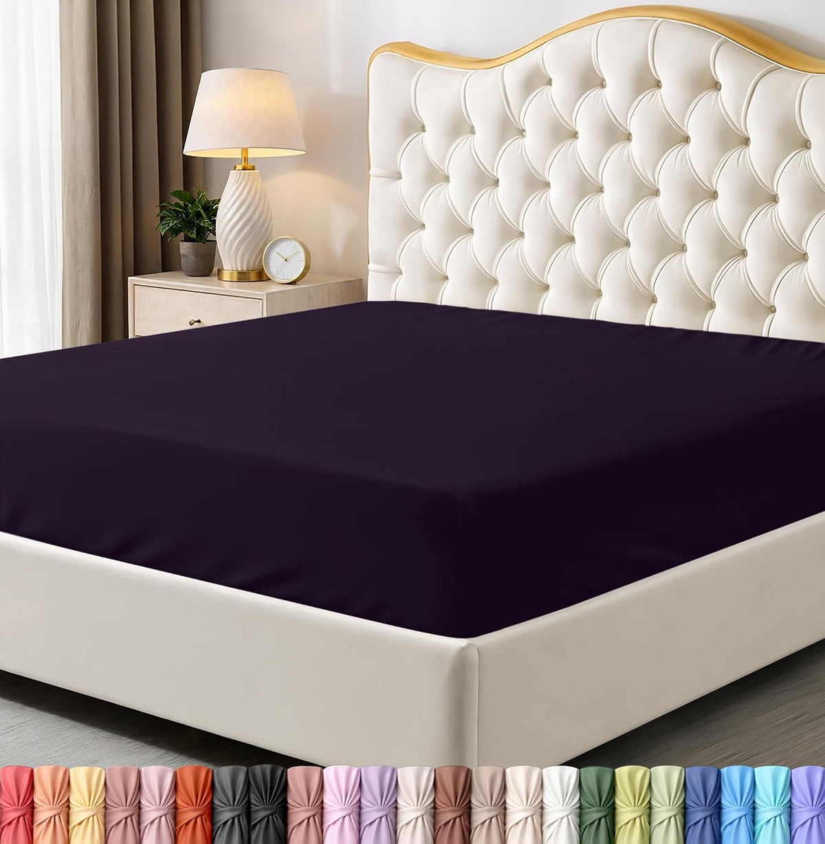 Bed with dark purple fitted sheet and decorative headboard in a bedroom setting.