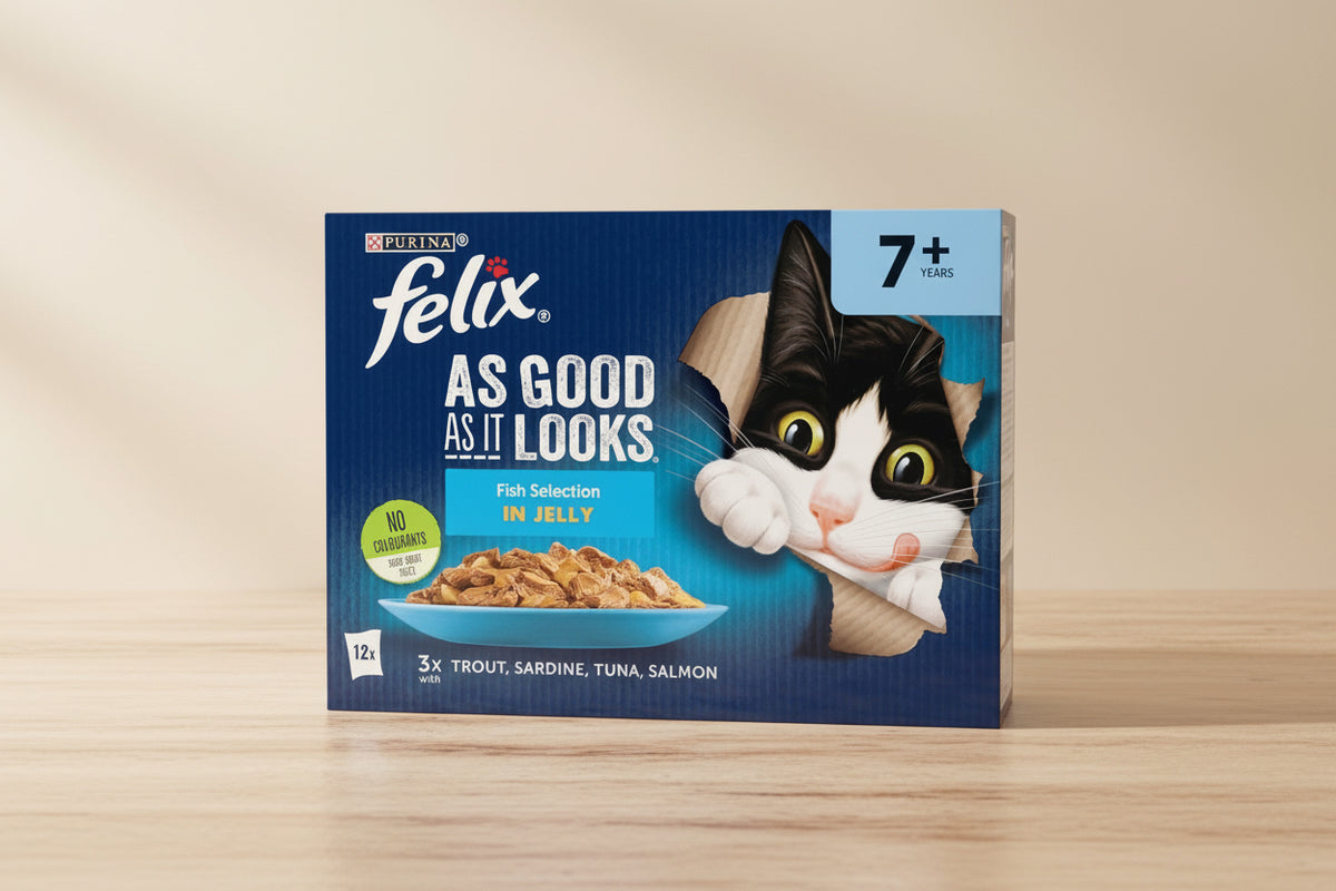 Purina Felix cat food packaging, Fish Selection in Jelly, featuring a black and white cat peeking through a torn paper effect on a dark blue background. The package shows a bowl of wet cat food and text indicating '7+ YEARS' and '3x Trout, Sardine, Tuna, Salmon'.