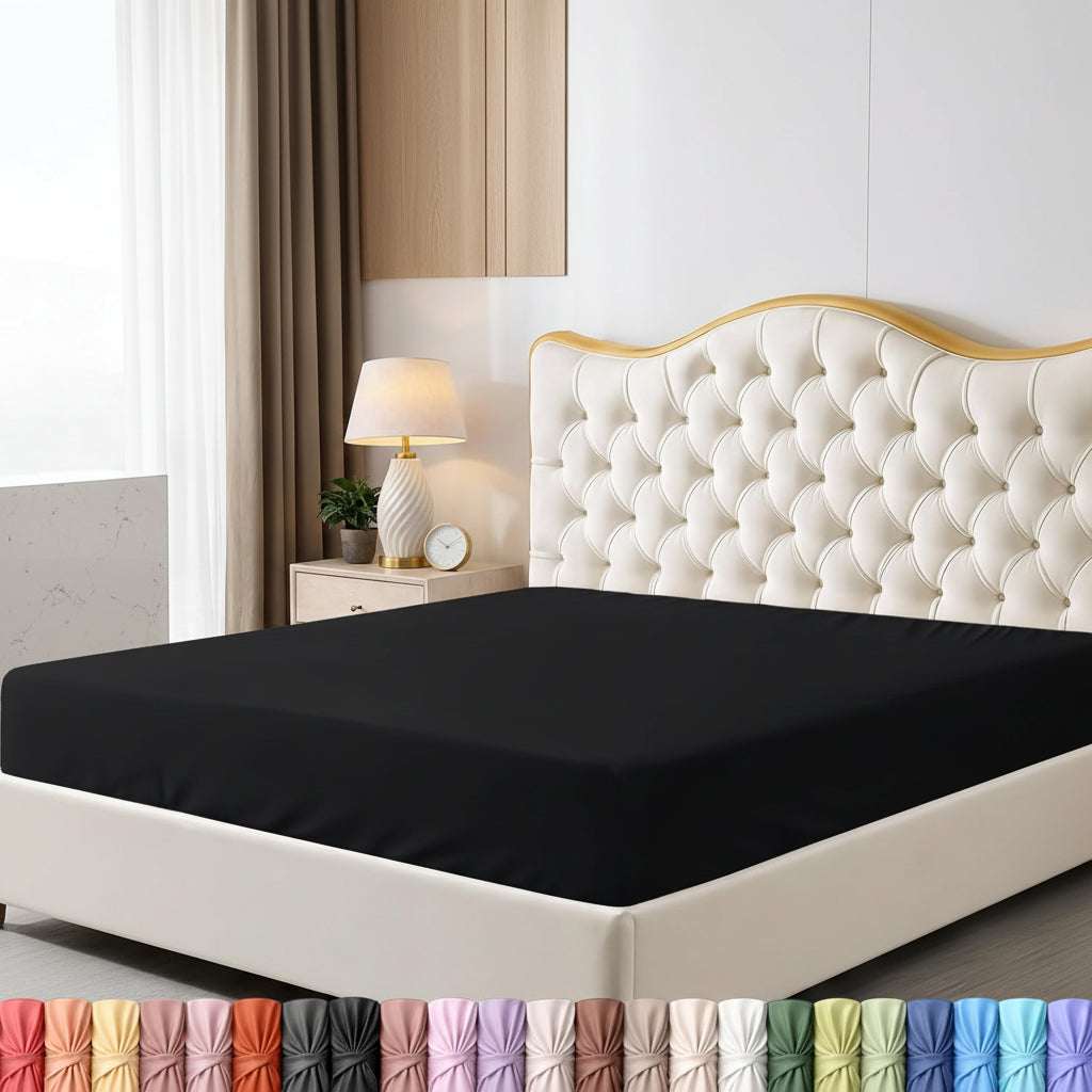 Black fitted sheet on a bed with a decorative headboard and nightstand in a bedroom setting.