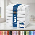 A stack of six folded fitted sheets wrapped in a blue paper band, shown on a white background with certification badges and a row of color swatches along the bottom.