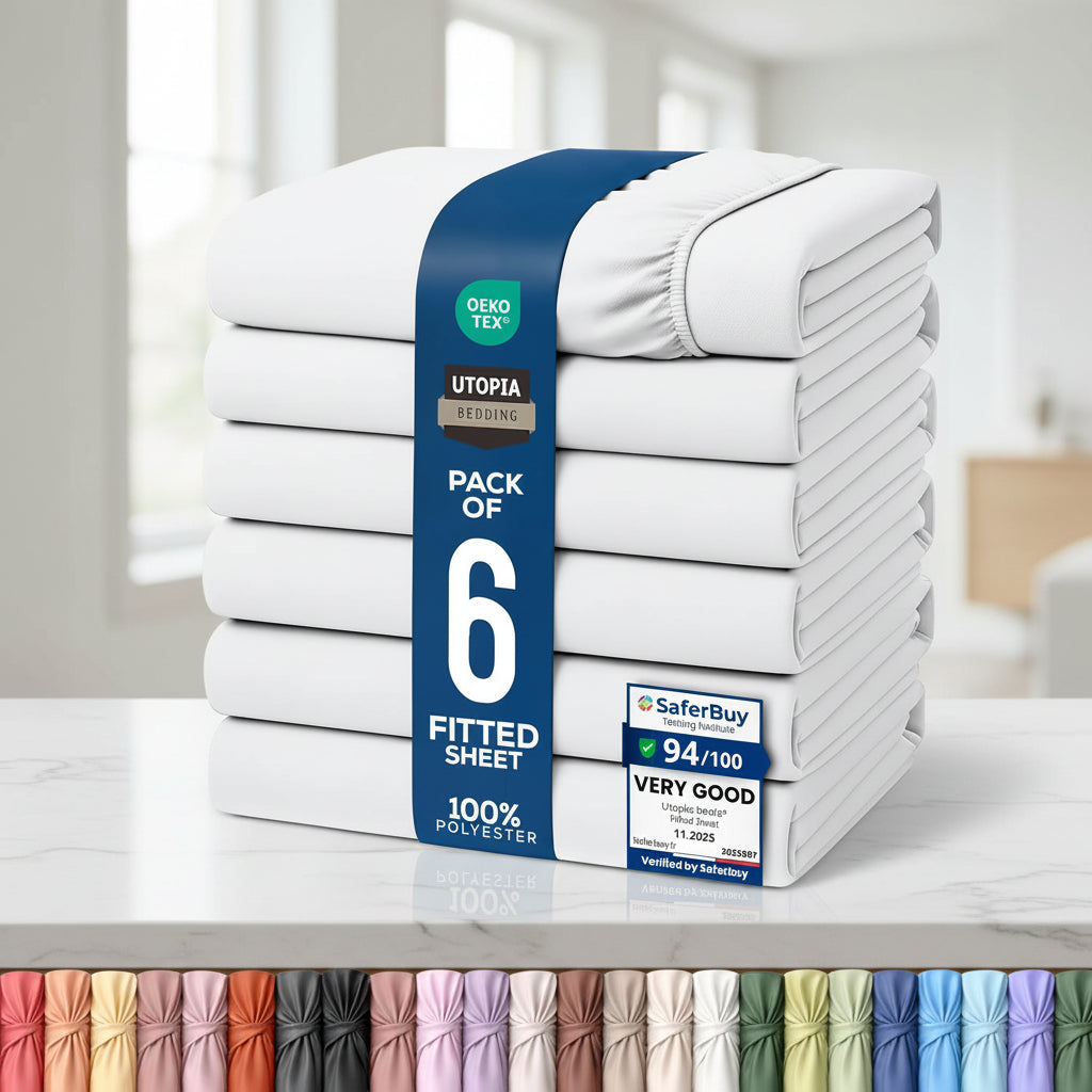 A stack of six folded fitted sheets wrapped in a blue paper band, shown on a white background with certification badges and a row of color swatches along the bottom.