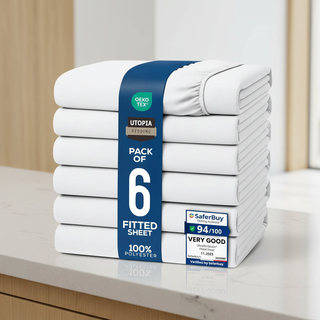 A stack of six folded fitted sheets wrapped in a blue paper band, shown on a white background with certification badges and a row of color swatches along the bottom.