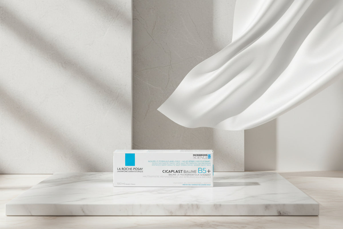A box of La Roche-Posay Cicaplast Baume B5+ cosmetic balm, featuring a white packaging design with blue and black text and a blue square accent on the left side.