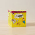 Yellow box of Dreamies cat food variety snack box with cartoon cat and treats on a white background