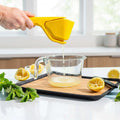 Set of kitchen utensils including spatulas and ladles in a drawer with text about space-saving design.