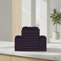 Stack of burgundy folded towels on a white background