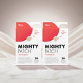 Two identical boxes of Mighty Patch The Original hydrocolloid patch pack shown side by side on a white background. The packaging features a red top flap with a beige patch illustration and text reading 'Hero.