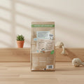 Back view of a 12kg bag of Barking Head's 'Food That Cares, Fed With Love' natural salmon fish food, featuring a teal background with white text, a purple header, and cartoon illustrations of a dog and salmon.