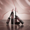 Four tubes of Maybelline New York Lash Sensational Length & Volume Mascara with the brushes extended, shown on a plain white background.