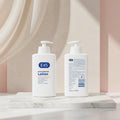 Two bottles of E45 moisturizing lotion on a pink background with text about skin improvement.