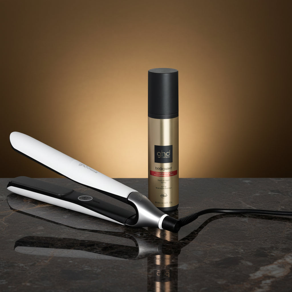 Hair straightener and bottle with text on a black background