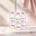 Three bottles of Garnier Micellar Cleansing Water All-in-1 Sensitive Skin, 400ml, with pink caps on a plain white background.